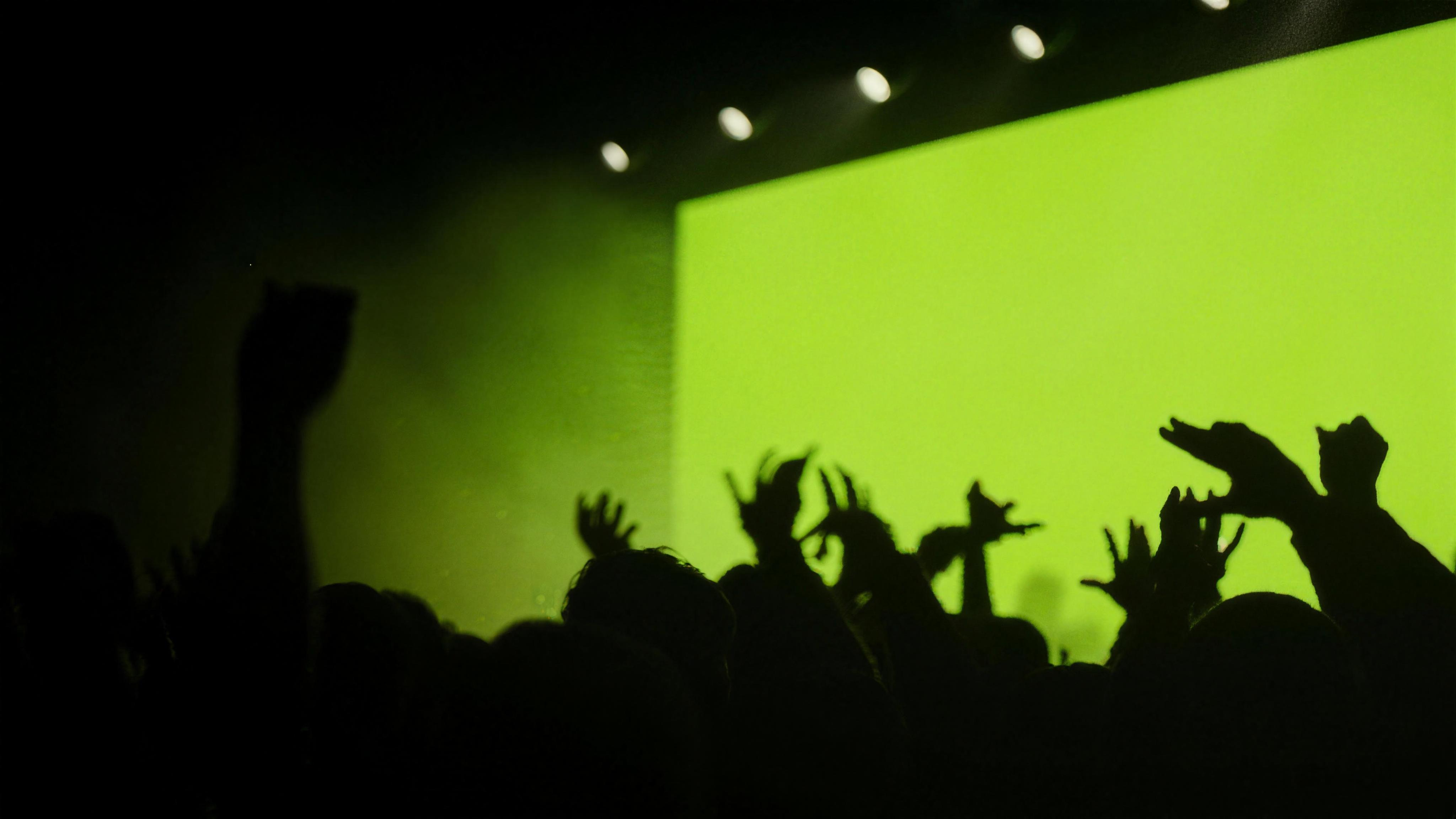 Broadcast camera operator covering a live concert with stage lighting