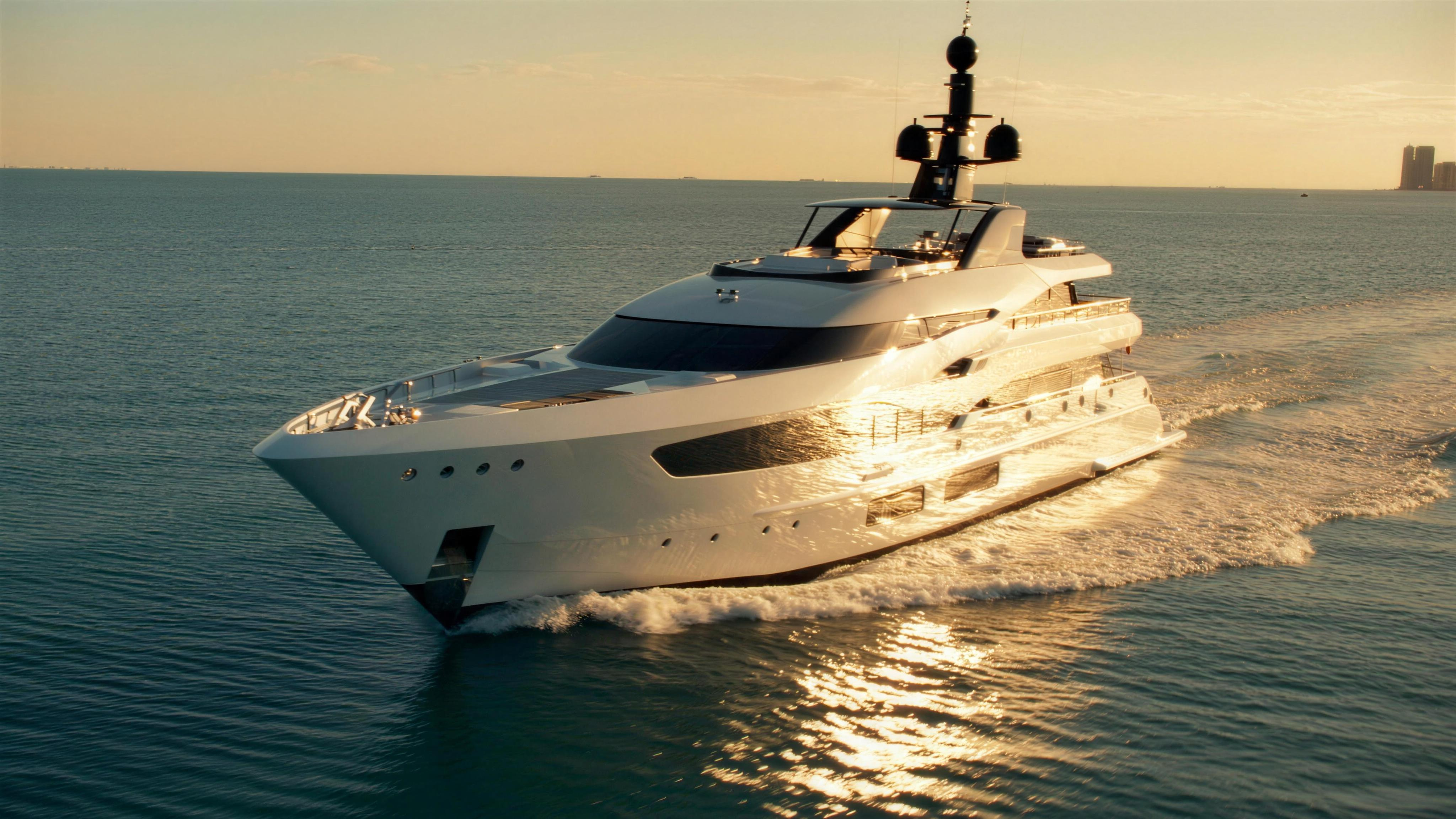 Camera boat filming a superyacht at sunset near Miami
